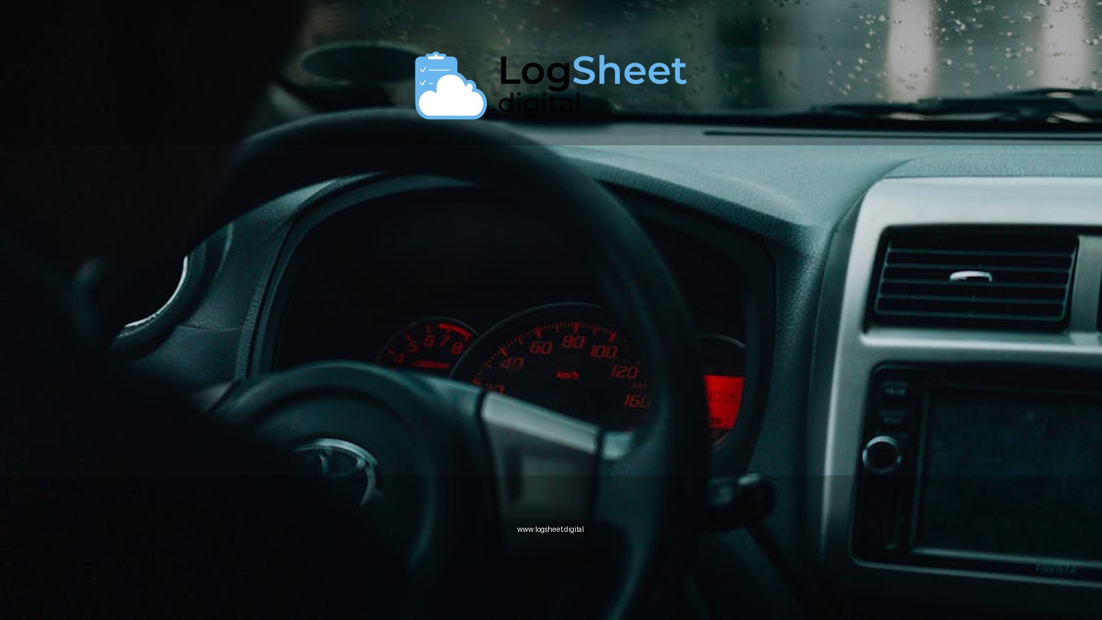 Interior car view with dashboard and raindrops, focusing on driving in rainy conditions.