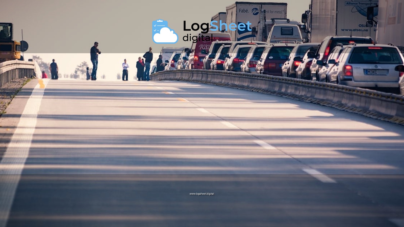 A congested highway with cars and trucks in a traffic jam during daylight.