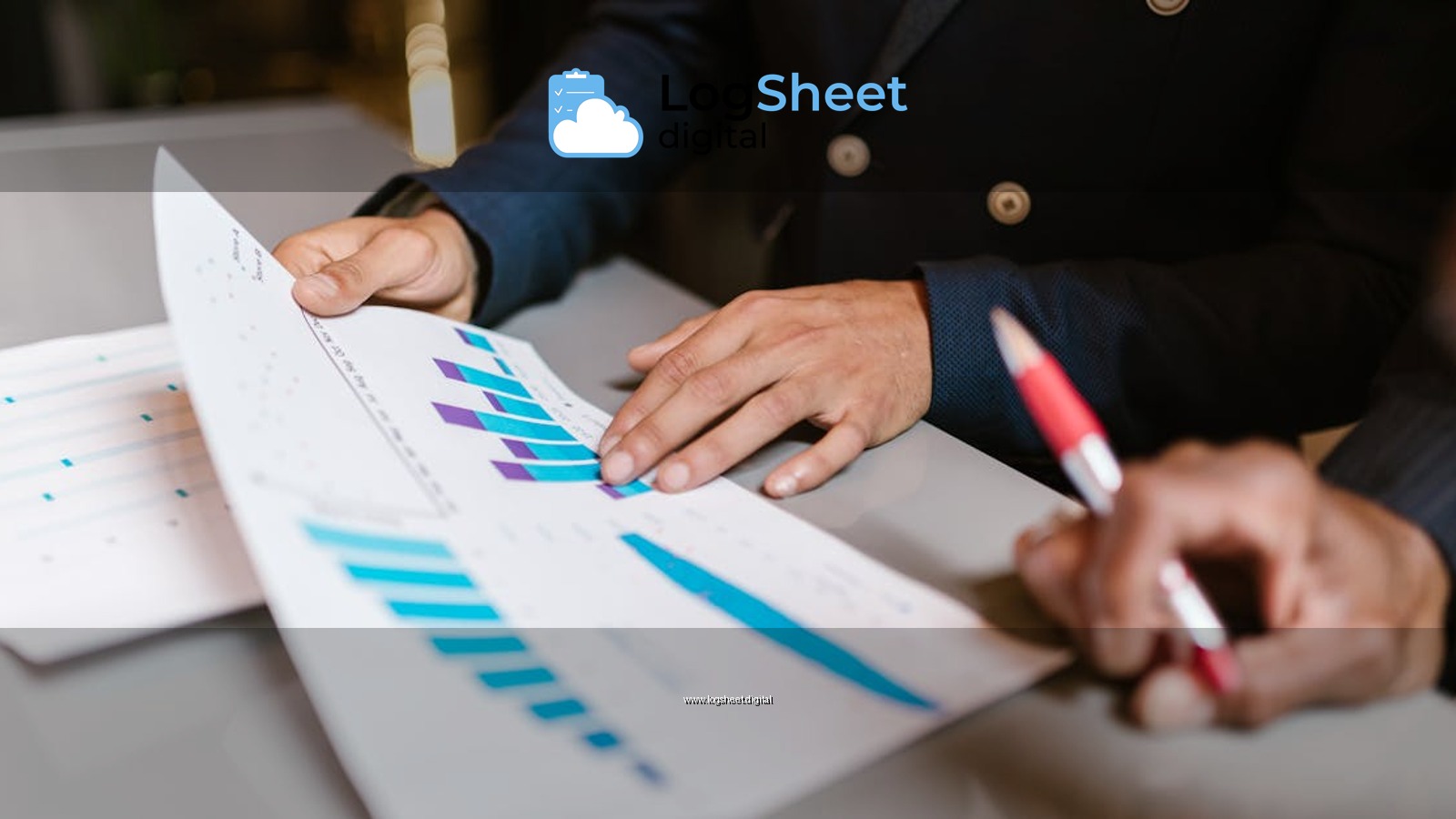 Close-up of professionals reviewing financial graphs at a business meeting.
