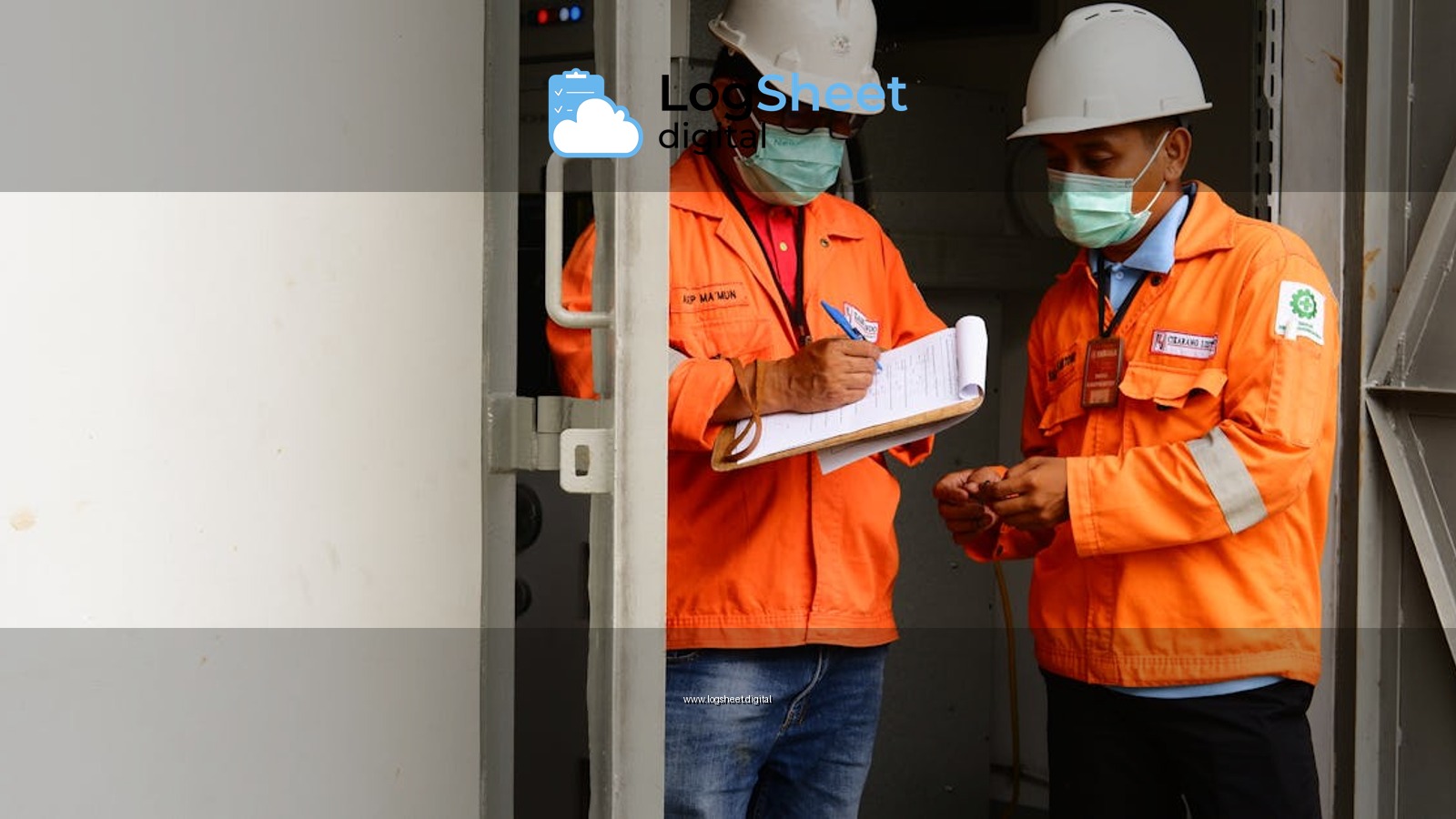 Two construction workers in safety gear discussing plans at a site entrance.