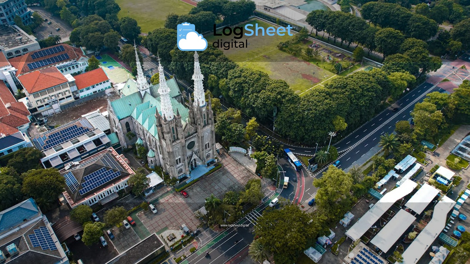 Aerial shot of Jakarta Cathedral showcasing its gothic architecture amidst lush greenery.