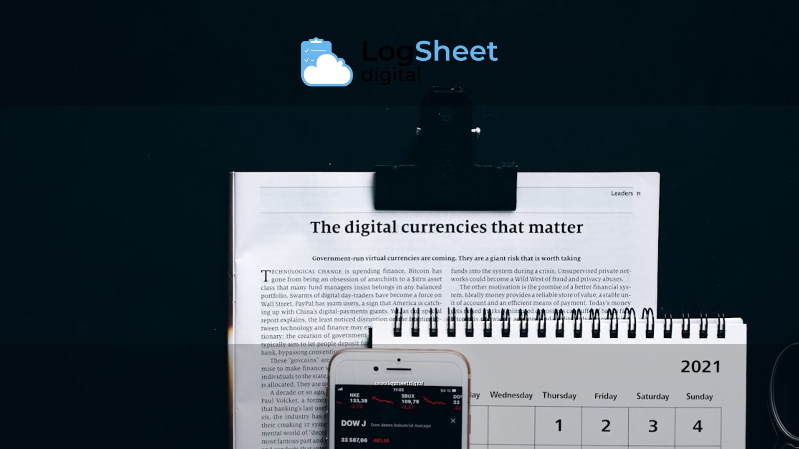 Digital currencies article with smartphone stock market app and calendar on black surface.
