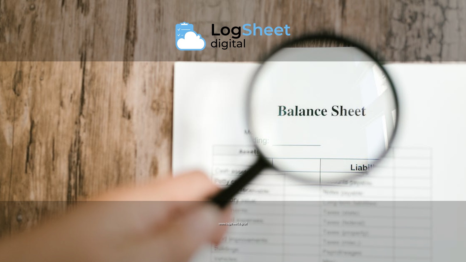 Close-up of a balance sheet document on wooden surface with a magnifying glass held by a hand.