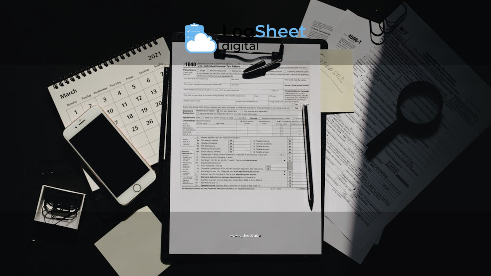 Flat lay of tax documents, calendar, and smartphone on a dark surface, symbolizing tax preparation.