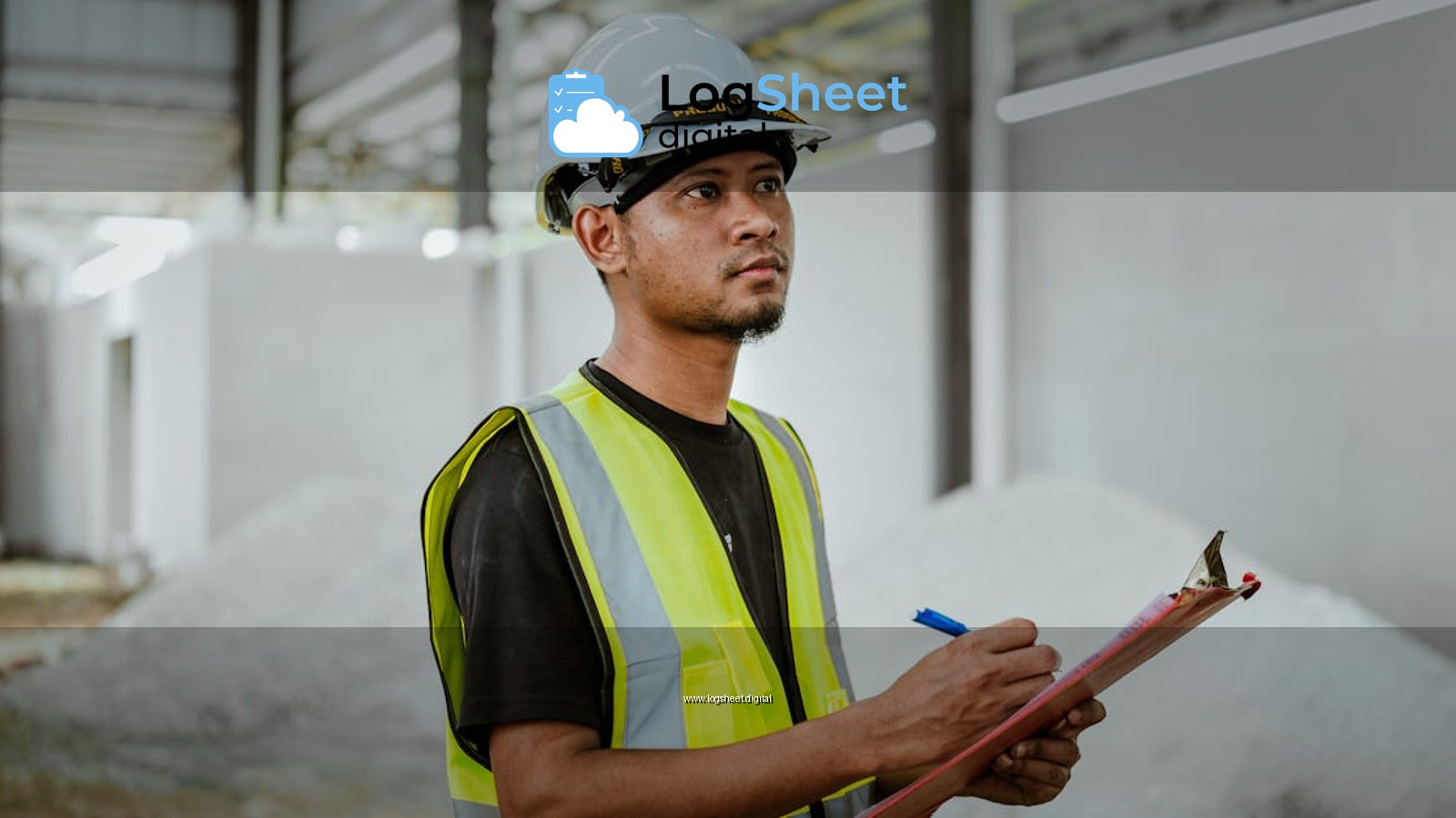 Asian construction worker in a factory setting, using a clipboard for inspection tasks in Banting, Malaysia.