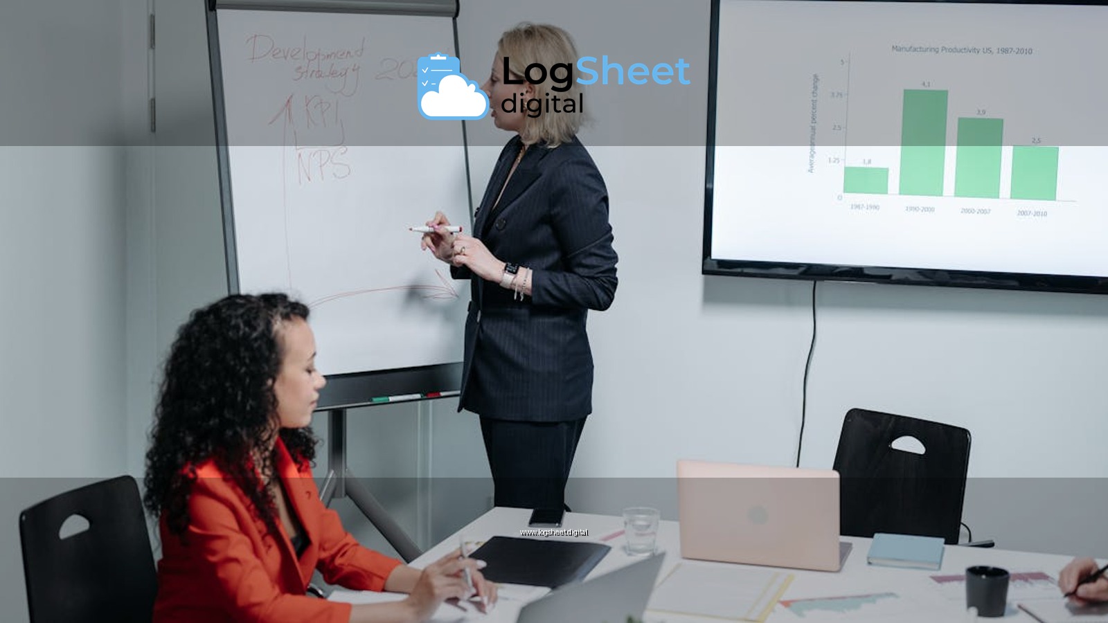 Businesswomen discussing strategy in modern meeting room with charts and analysis.