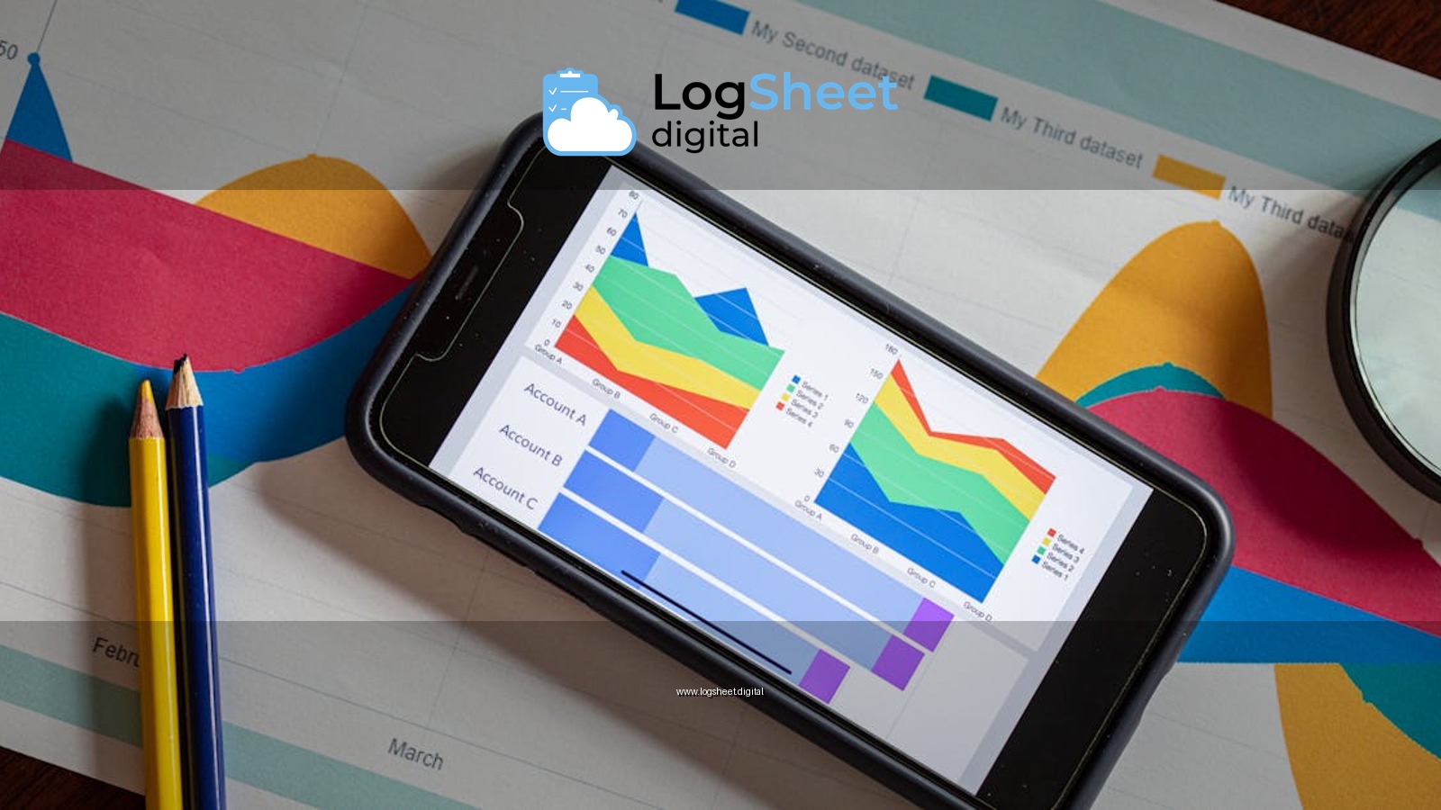 Overhead view of a smartphone displaying colorful charts on paper graphs, symbolizing mobile data analysis.