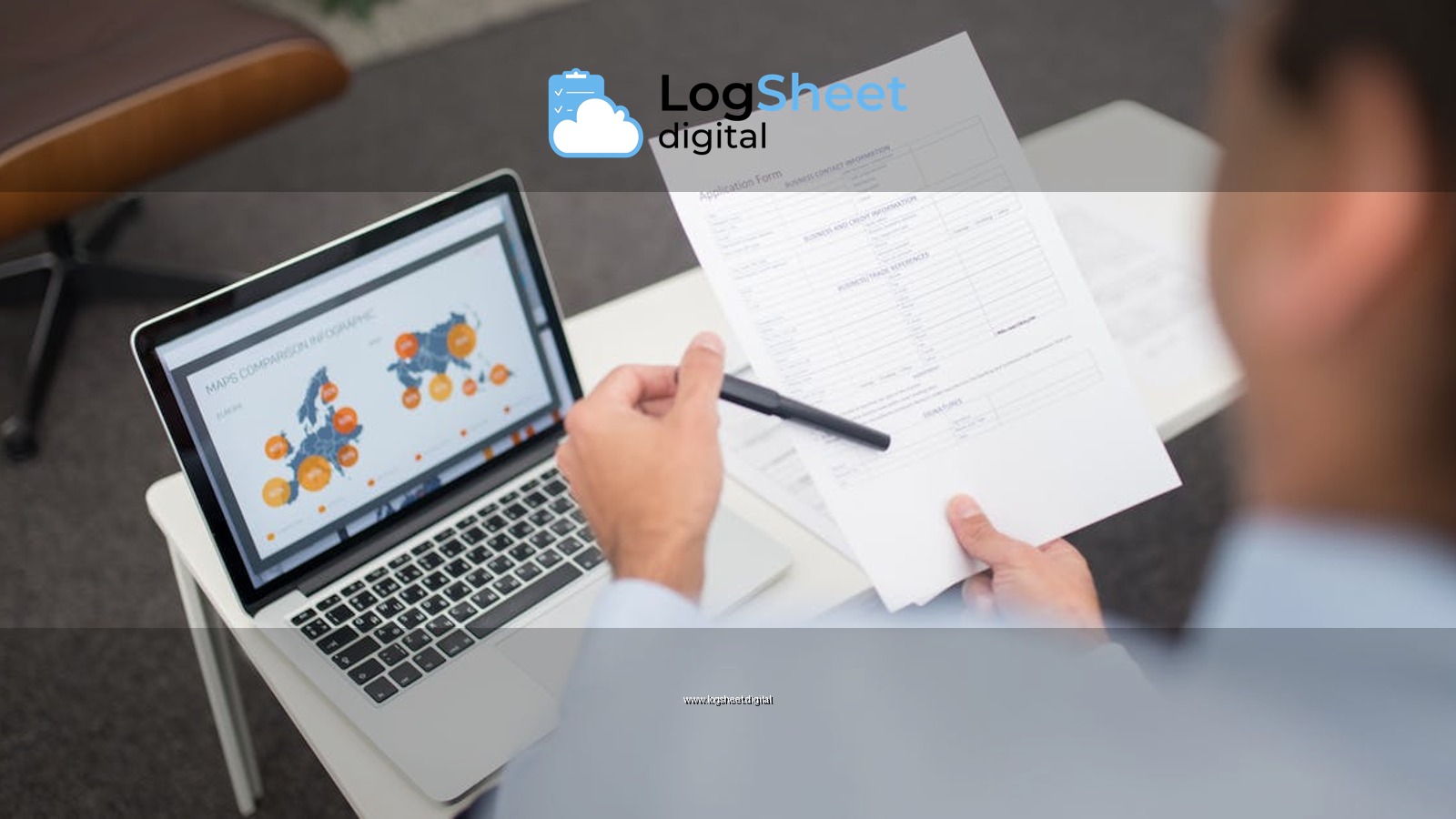 Professional setting with businessman reviewing documents and data on a laptop in an office.