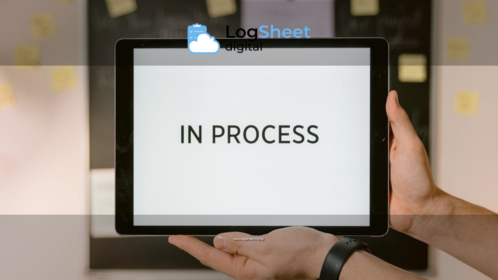 Close-up of hands holding a tablet displaying 'In Process' text, emphasizing workflow.