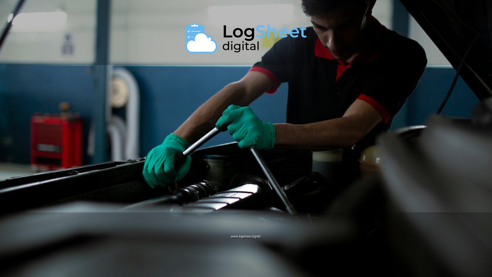 Mechanic wearing gloves using a torque wrench to repair a car engine in an indoor garage.