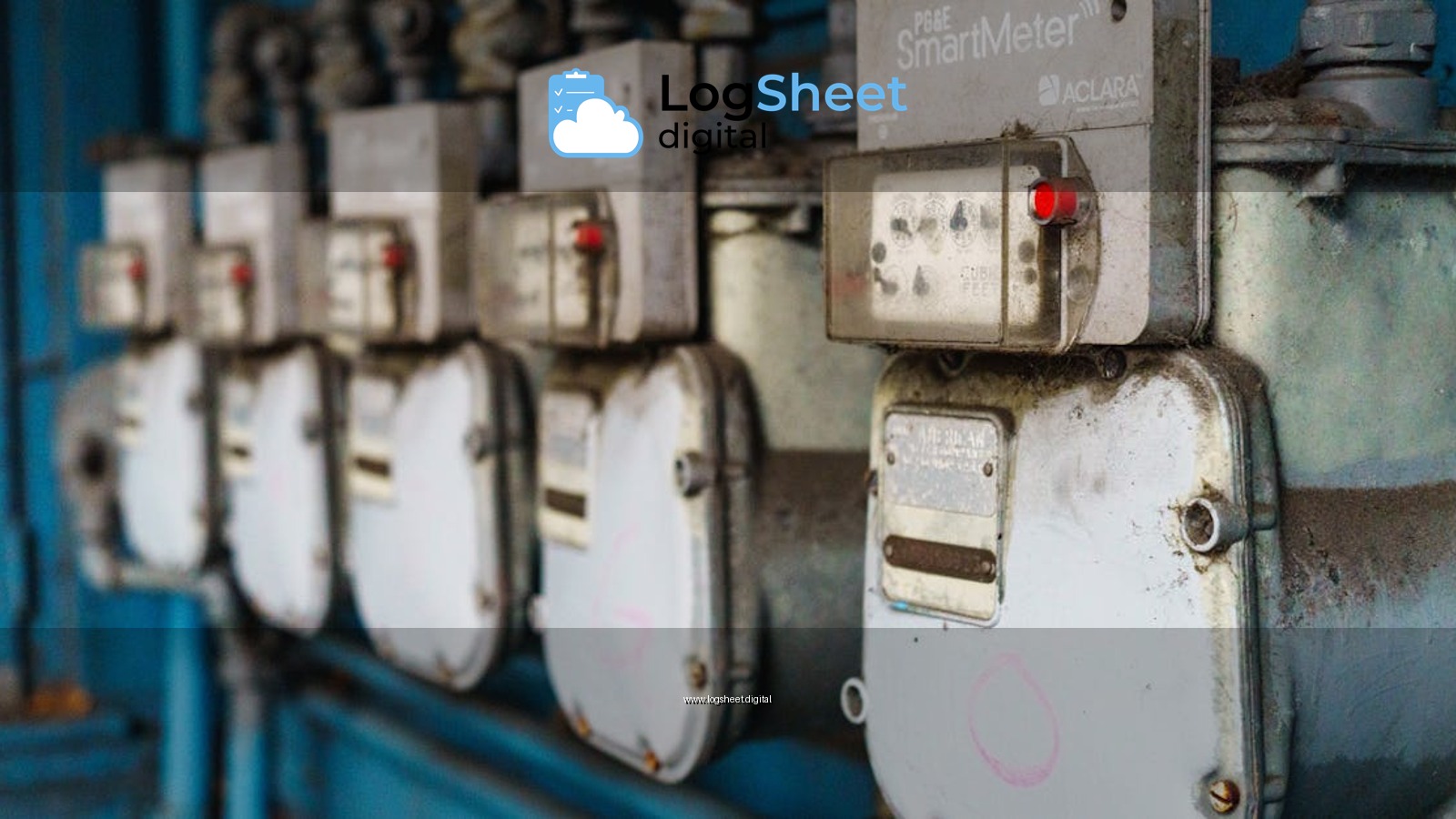 Multiple smart utility meters lined up on a blue industrial wall.