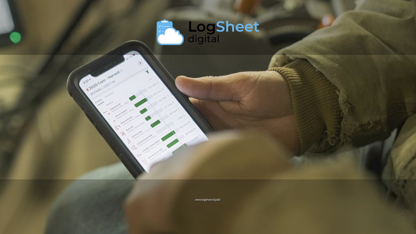 Close-up of a person in winter clothing analyzing farming data on a smartphone screen.