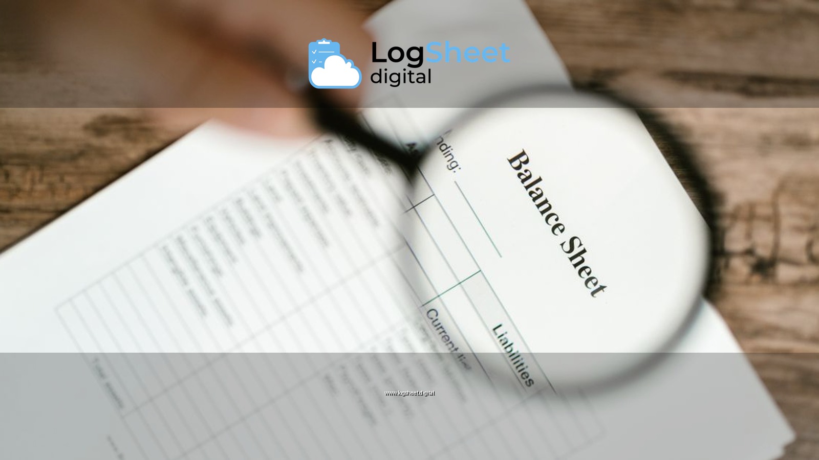 Close-up of a balance sheet under a magnifying glass on a wooden table.