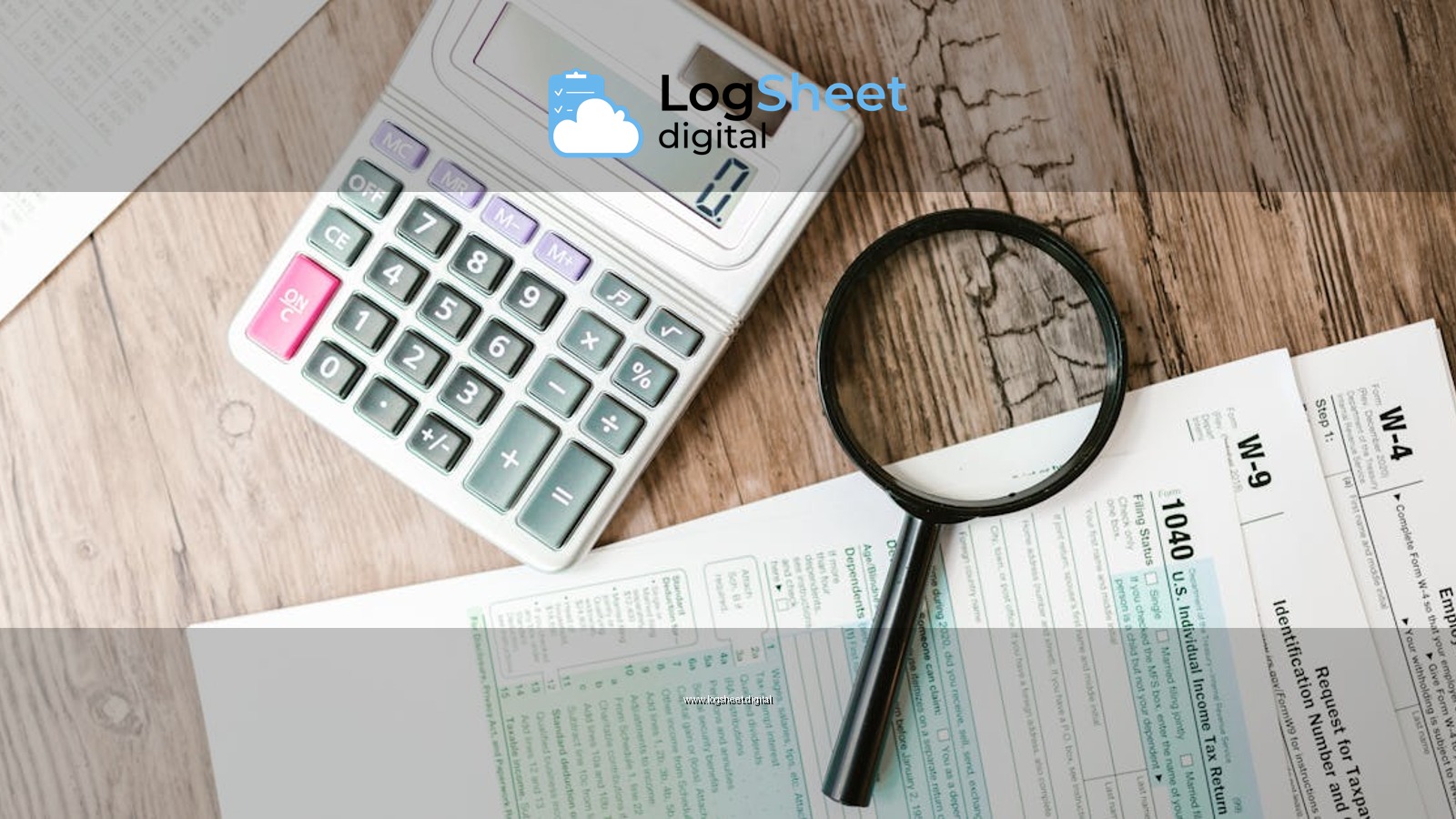 Tax forms laid out with a calculator and magnifying glass on a wooden surface, perfect for finance themes.