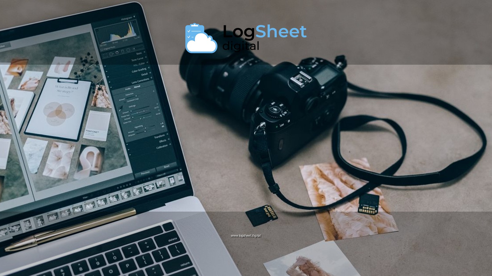 Laptop with editing software alongside DSLR camera and memory cards on a desk.