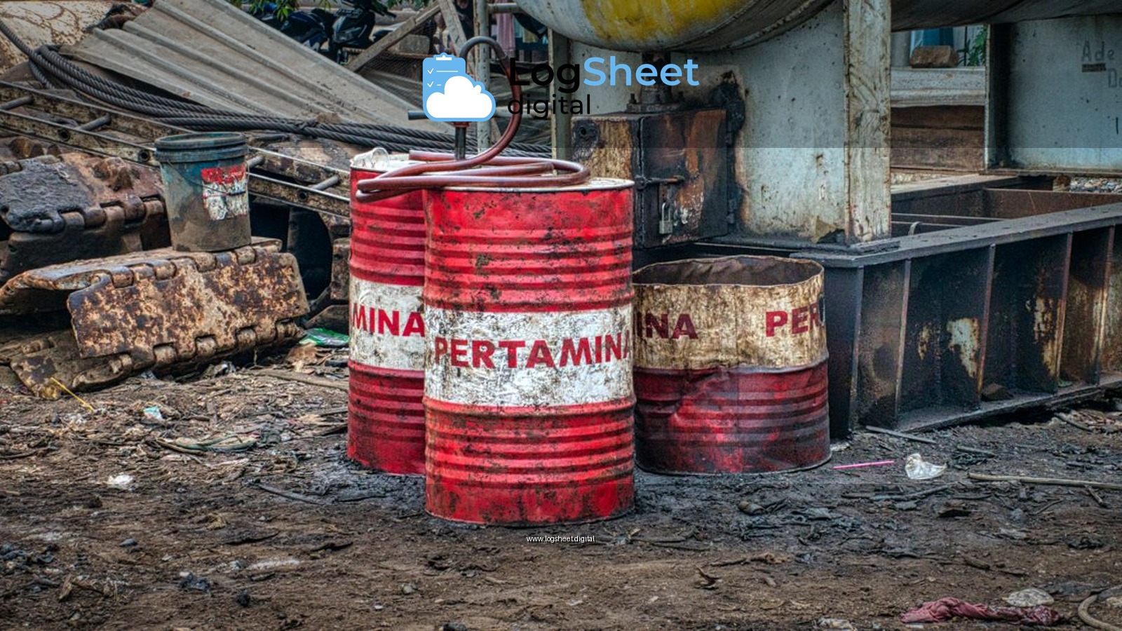 Old red metal barrels with inscription placed on ground in landfill in daylight