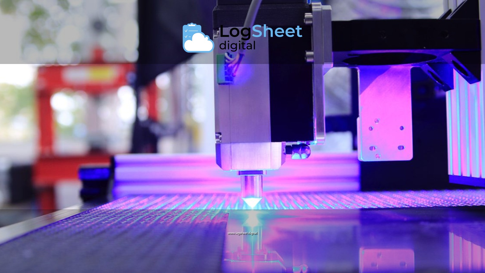 Close-up of a laser engraving machine working indoors with blue light reflection.