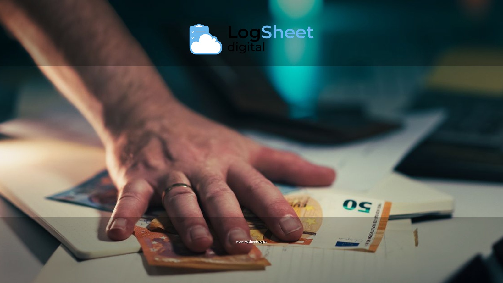 Close-up of a hand grabbing euro bills from a cluttered desk, symbolizing finance or financial crisis.