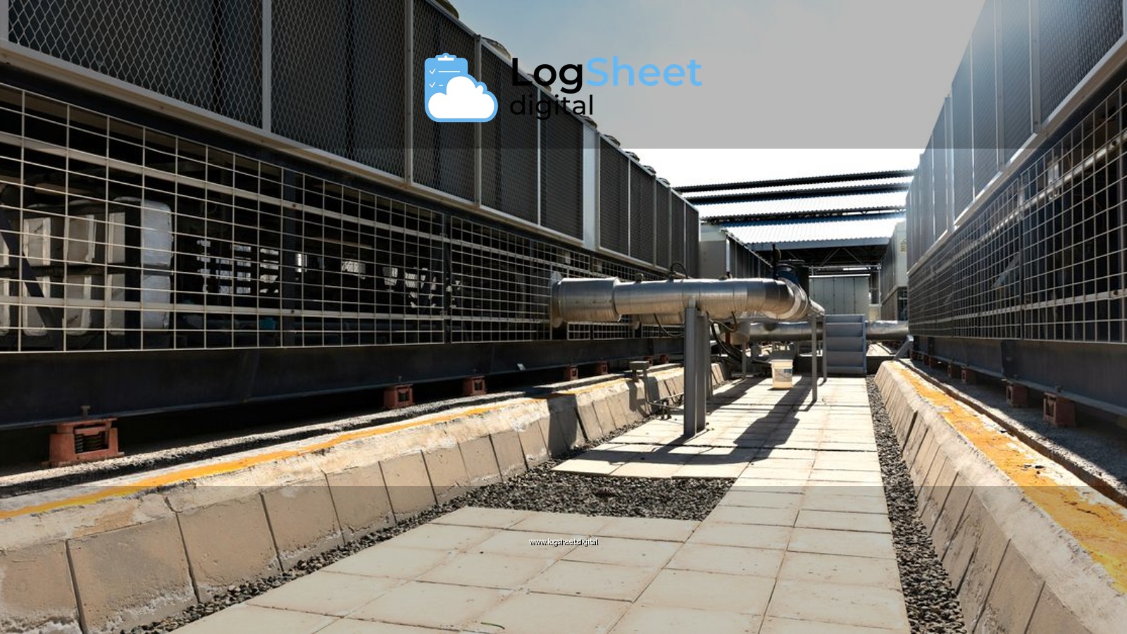 View of a large industrial cooling system with metal pipes and grids outdoors under bright daylight.