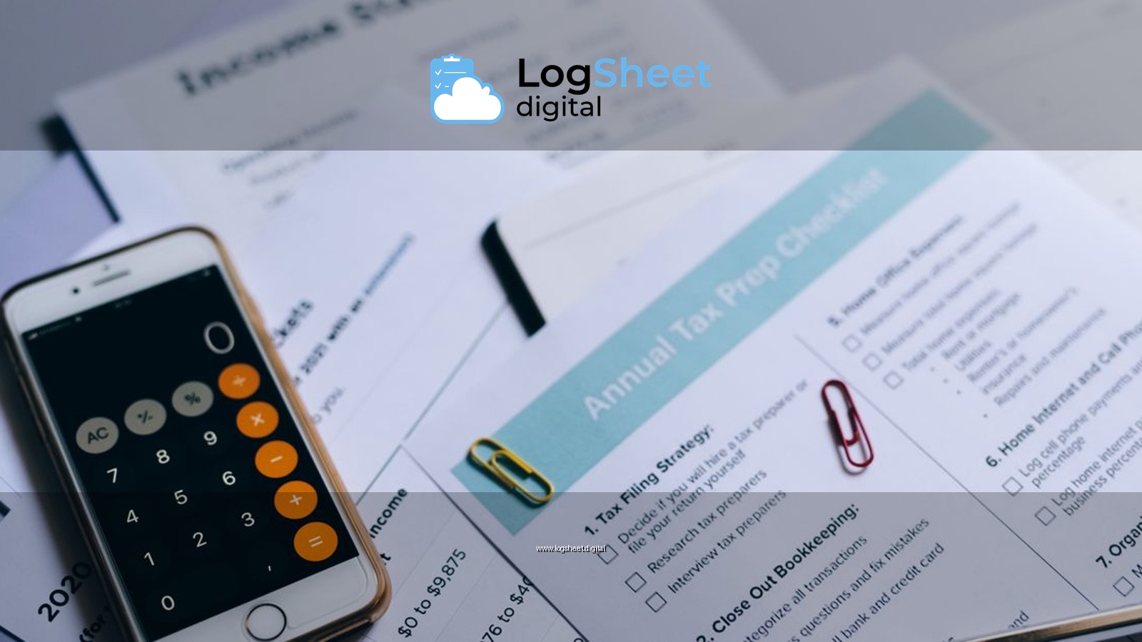 Tax preparation setup with documents, smartphone calculator, and checklist.