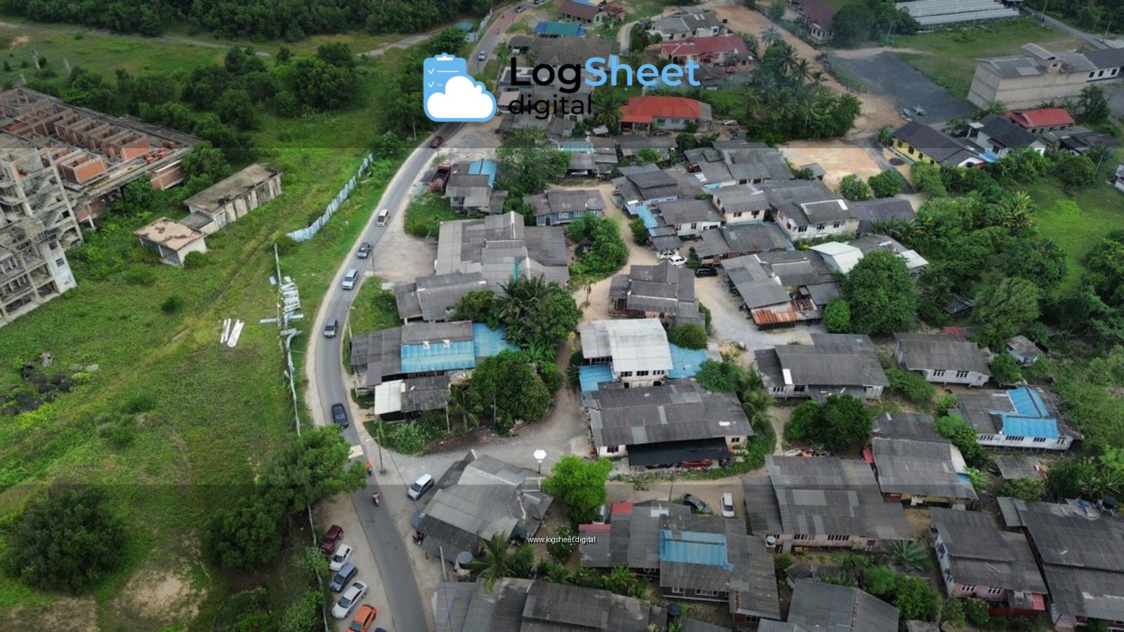 Aerial view of a residential area featuring homes, greenery, and nearby construction site.