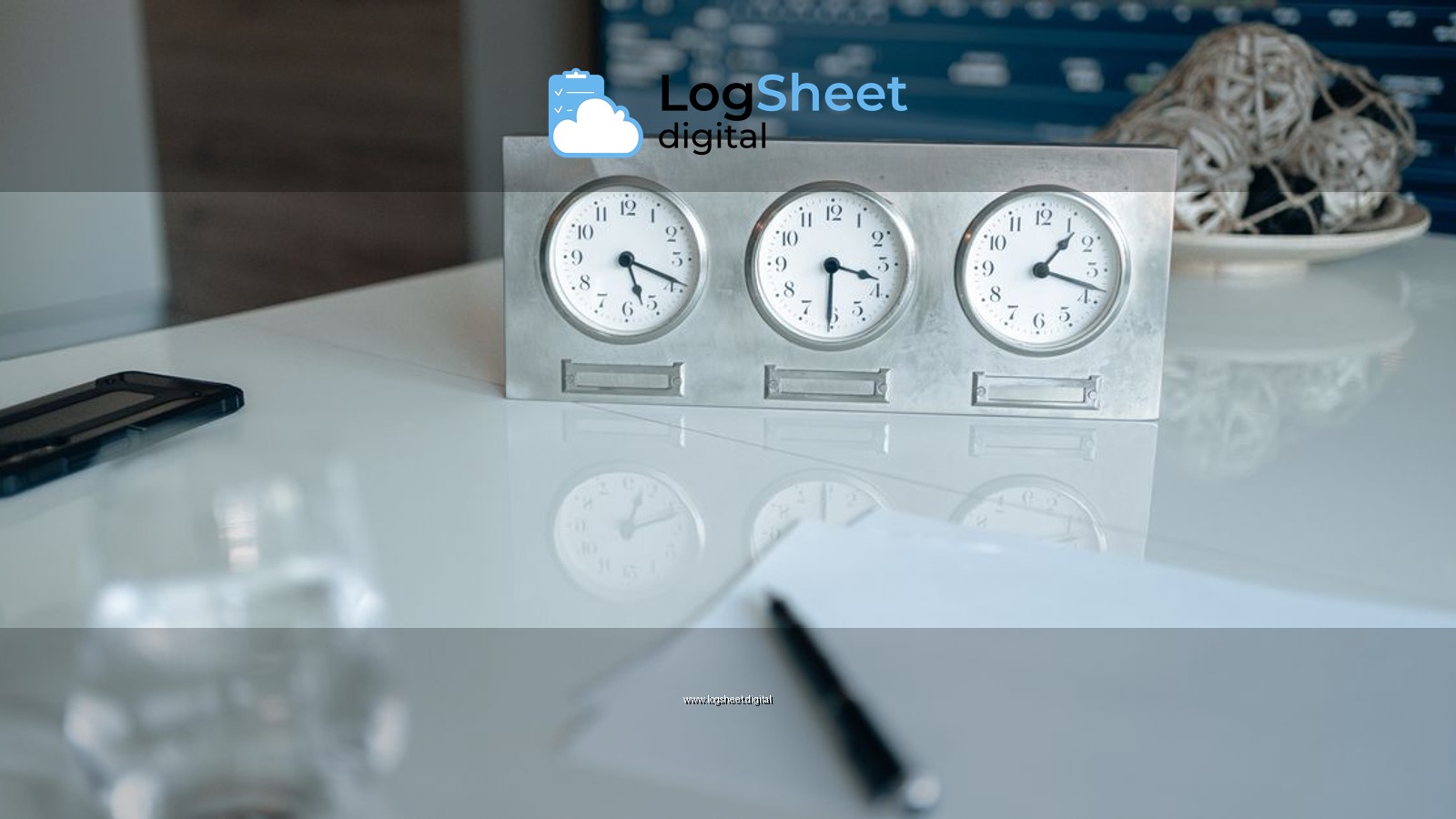 Professional workspace featuring three clocks and financial data on screen.