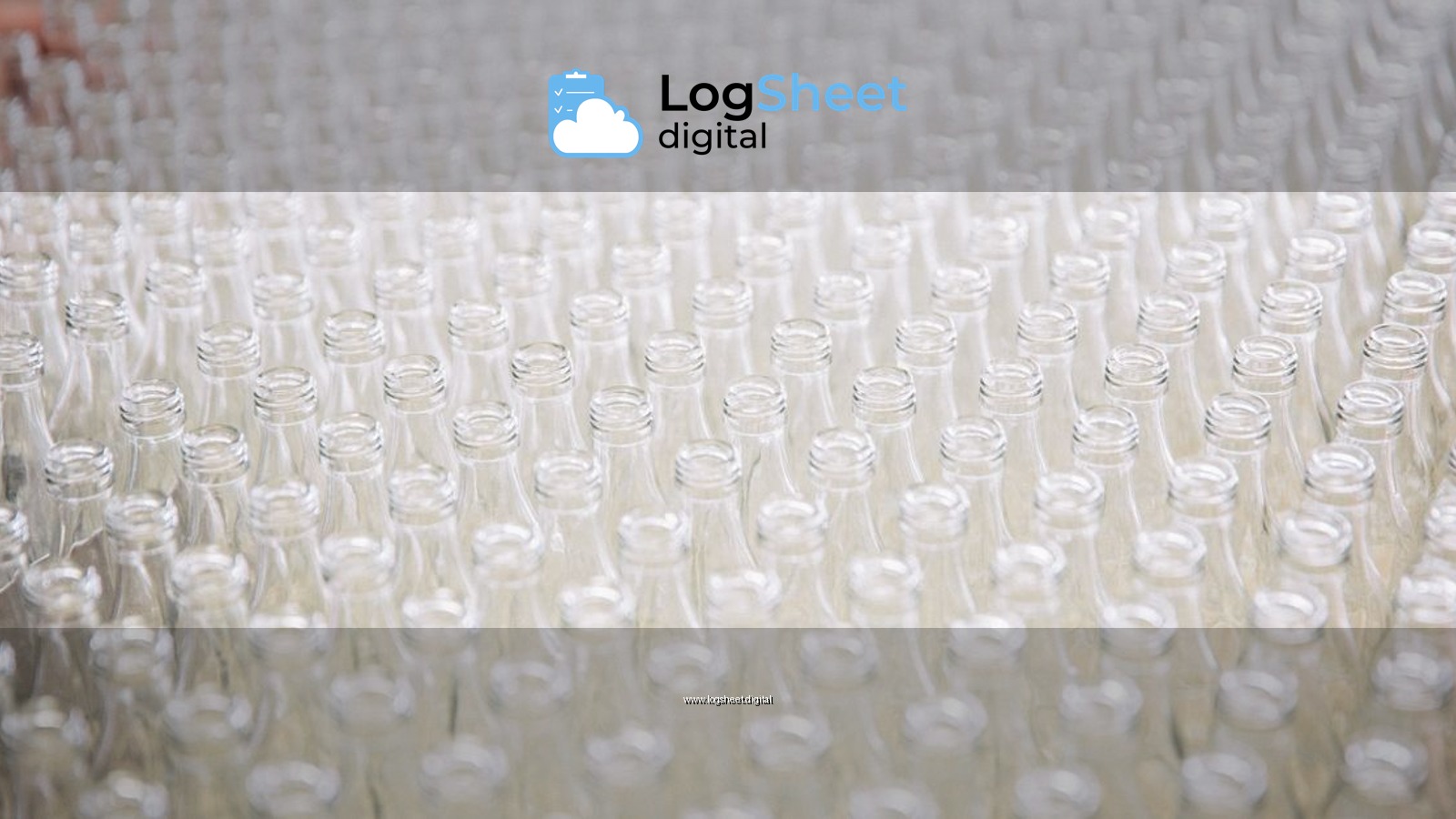 A close-up of numerous transparent empty glass bottles arranged in neat rows.