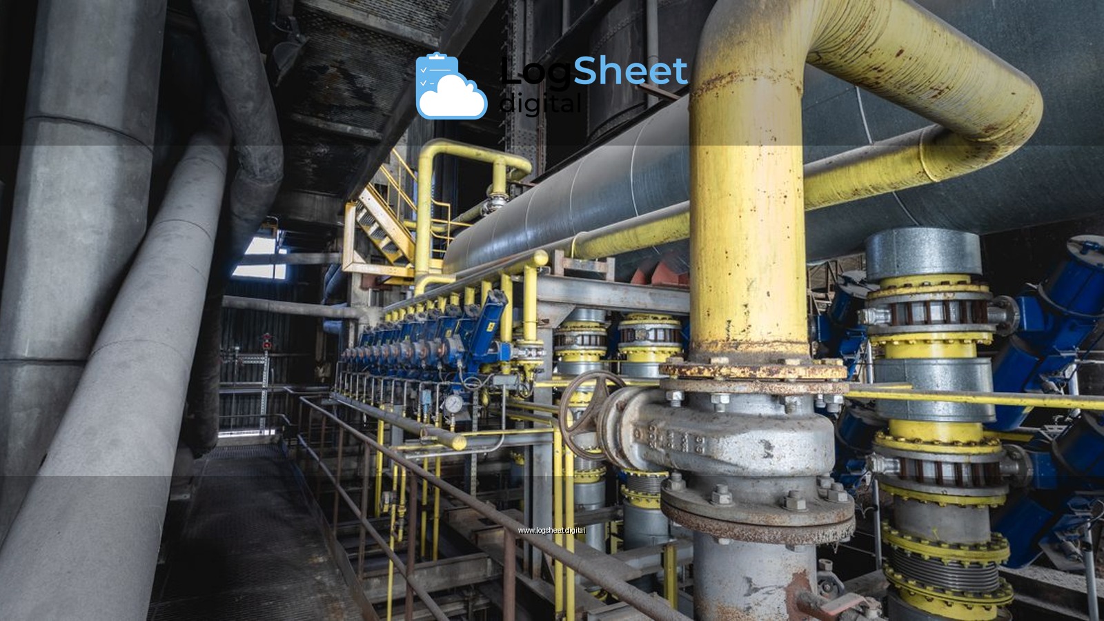 Close-up of an intricate industrial pipeline system featuring yellow valves and steel structures inside a factory.