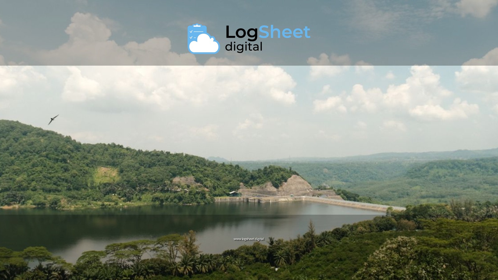 Panoramic landscape of a dam with lush greenery and a clear sky, depicting nature's tranquility.
